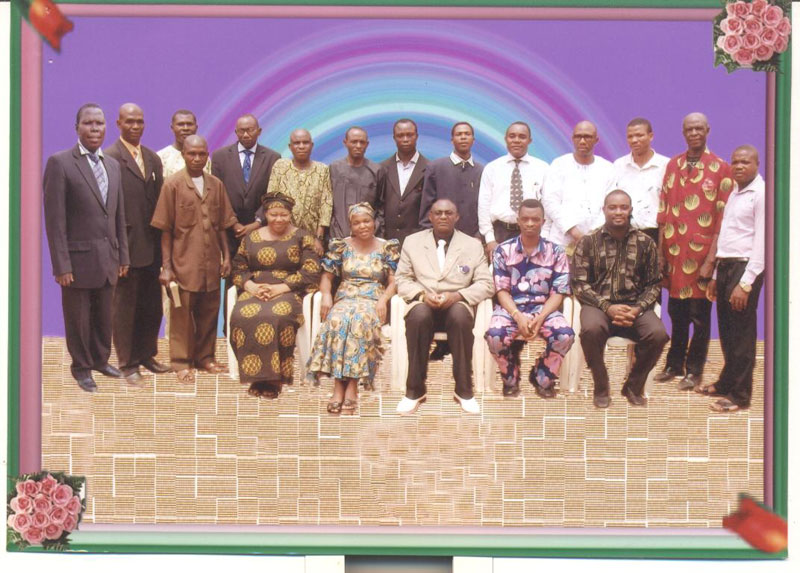 Back row standing left to right: Pastor Emmanuel Okonkwo, Evangelist Obeta Anthony, Pastor Obinna Goodness, Rev. Dr. Sam Olisa DikeEvang. Ifeanyi Agwunobi, Evang. Okwuosa Nnamdi, Pastor Gideon Ihesiaba, Evang. Sam Obeta, Evang. Godwin O. Nelson, Pastor Fillas James Chidozie, Missionary M. C. Ezejiofor, Apostle Benedict Okeke, Pastor Dr. Emeka Nkama. Standing alone amongst the members seated: Pastor Peter Eze. Front row seated: Rev. [Mrs.] Chinwe Odikpo, Rev [Mrs.] Nkem Igwagu, The Coordinator — Apostle Berty Agbanusi, Rev. Chuks Okoro and Evang. Akachukwu Okoye. MINISTERS SOLM ONITSHA OFFICE, Nigeria, West Africa.